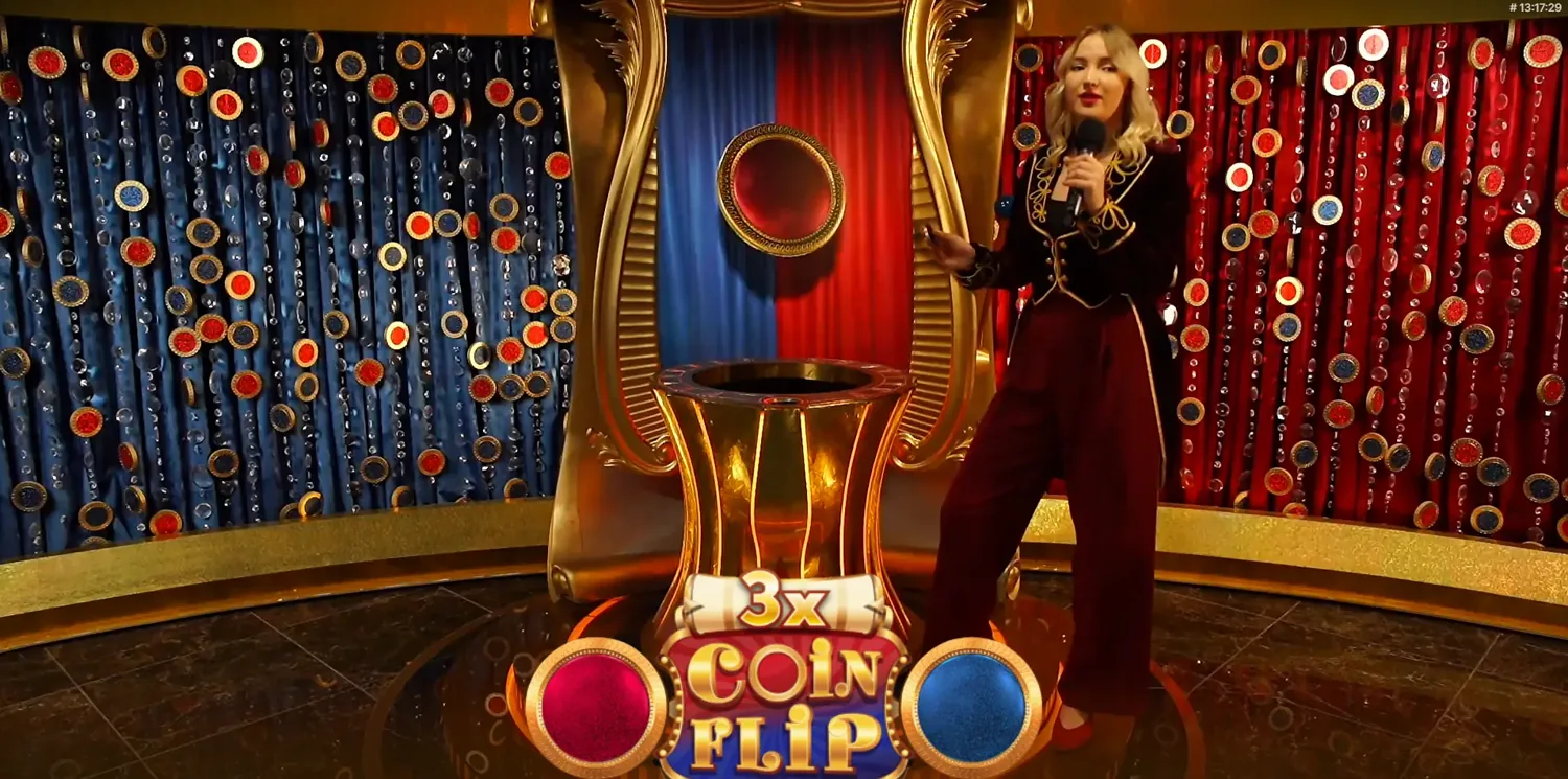 The red and blue Crazy Coin Flip machine with the live host on set